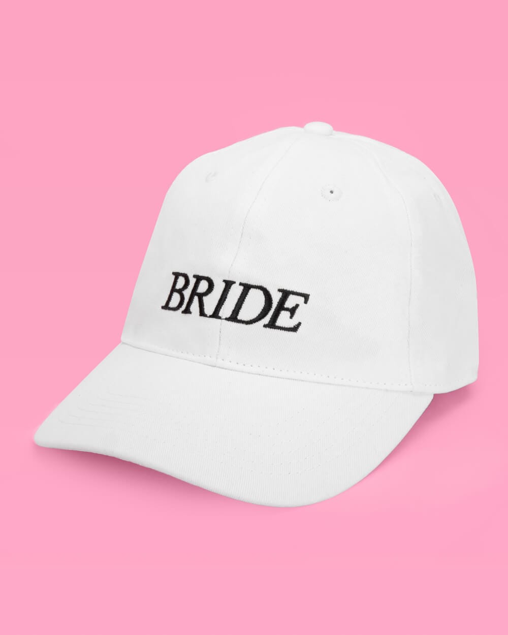White baseball cap embroidered with "BRIDE" text on pink background