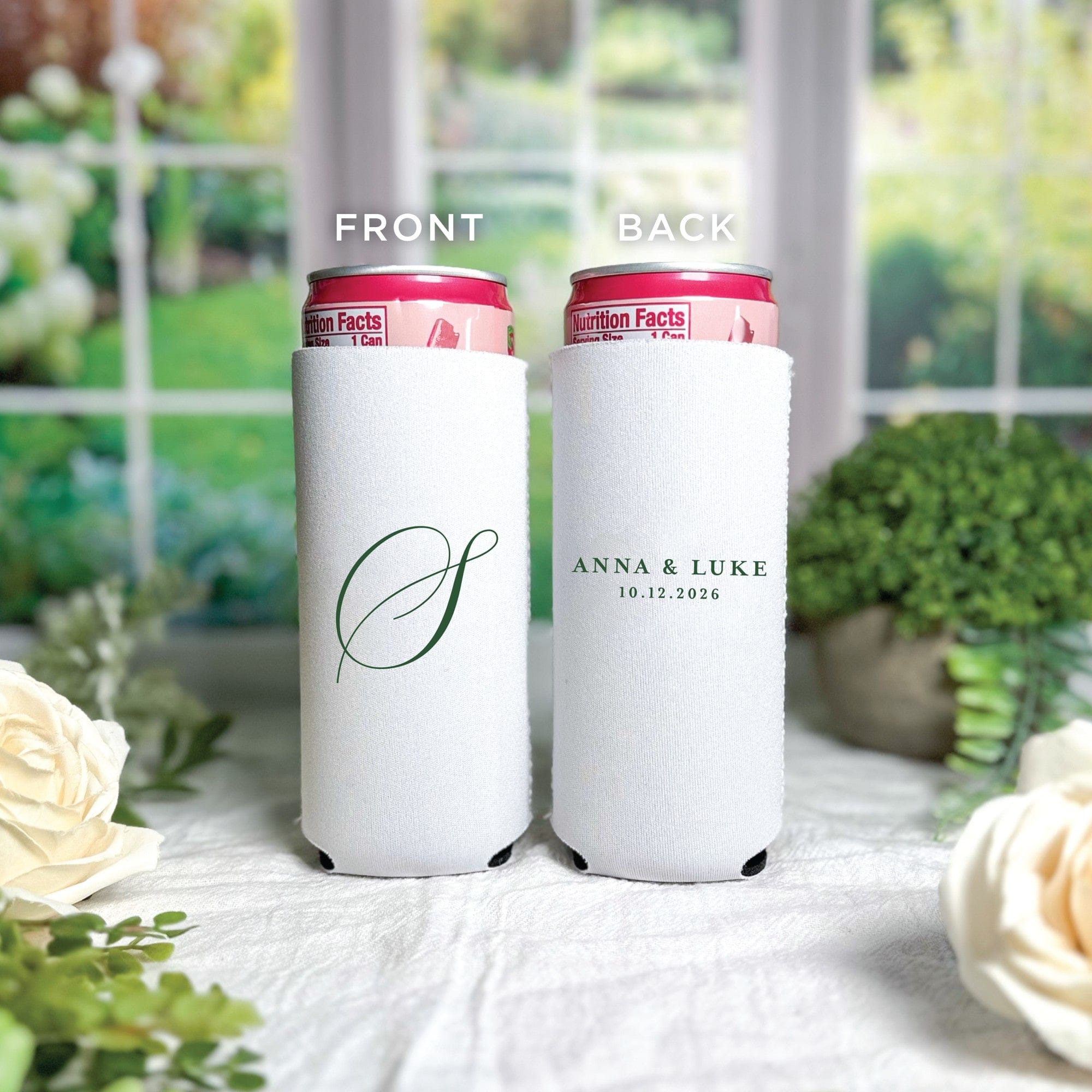 Two personalized white neoprene slim can coolers for a wedding event, one featuring a green script initial and the other with green text for a couple's names.