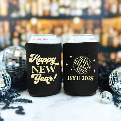A pair of black neoprene can coolers for a New Year's Eve celebration, each featuring a festive design in a light color.