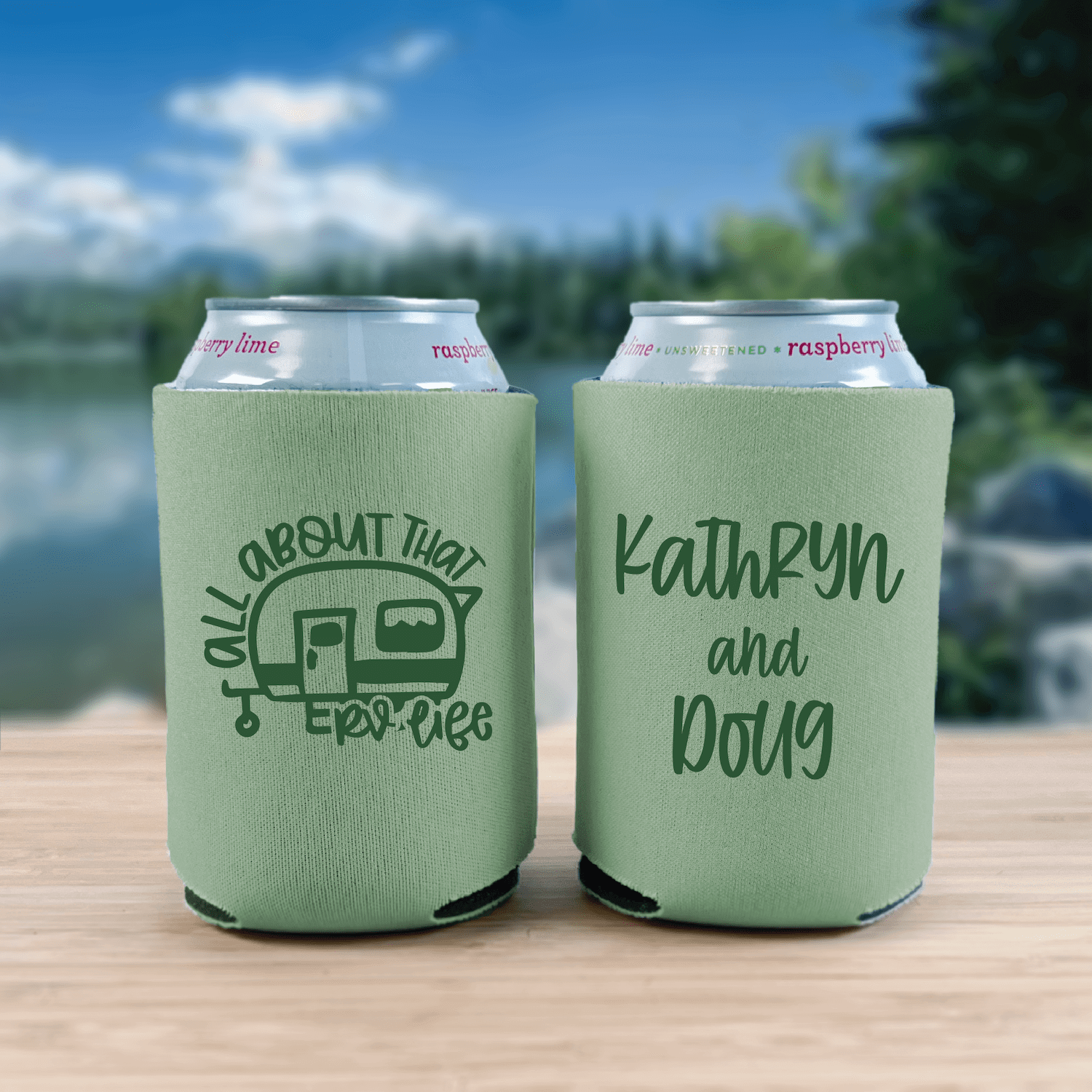 Pair of sage green can coolers with "All About That RV Life" and personalized names Kathryn and Doug printed in black text
