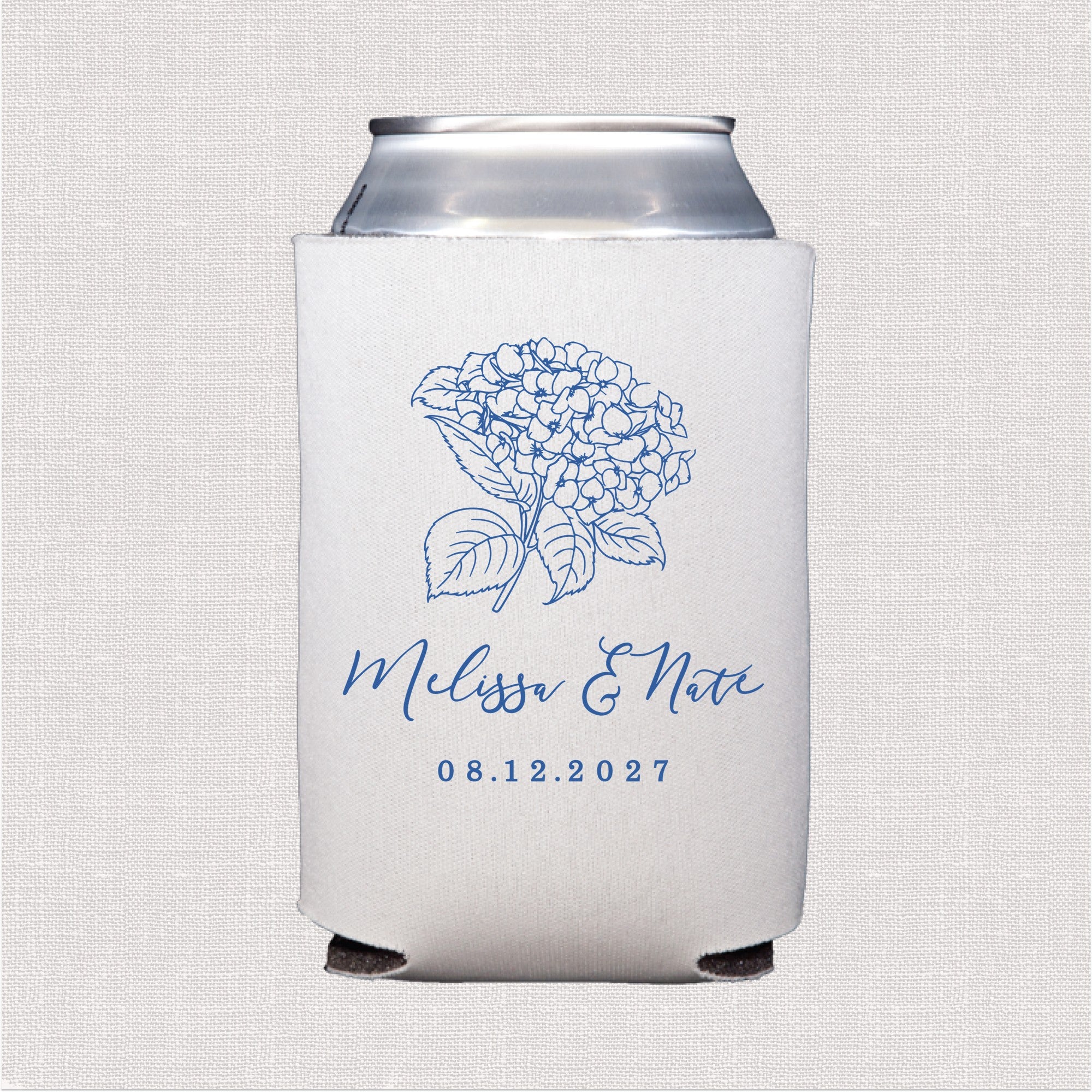 A white neoprene can cooler featuring a blue outline hydrangea floral design, perfect for keeping beverages cool at a wedding event.