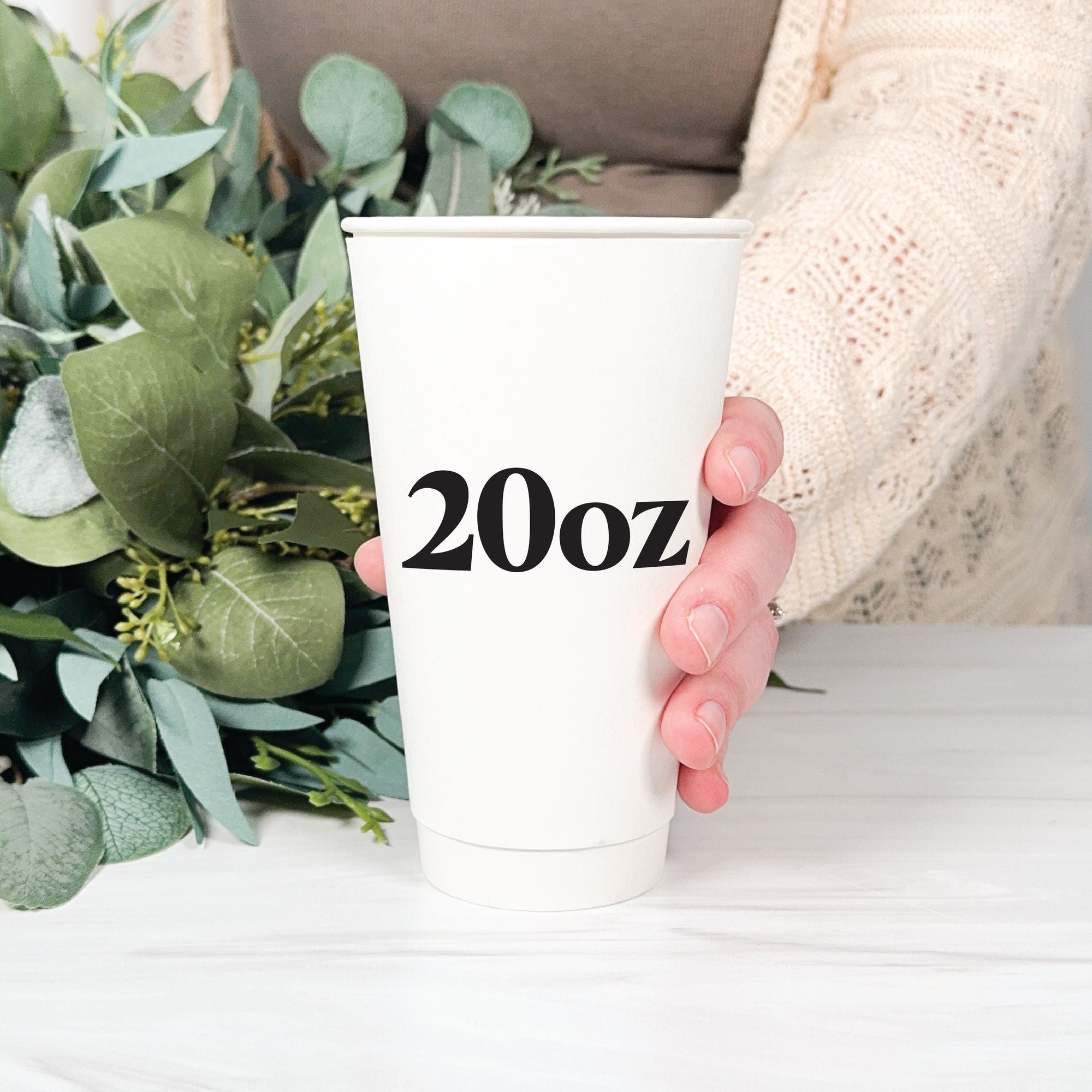 Personalized Paper Wedding Cups Design Your Own 20oz large cup held against soft botanical backdrop – Rubi and Lib