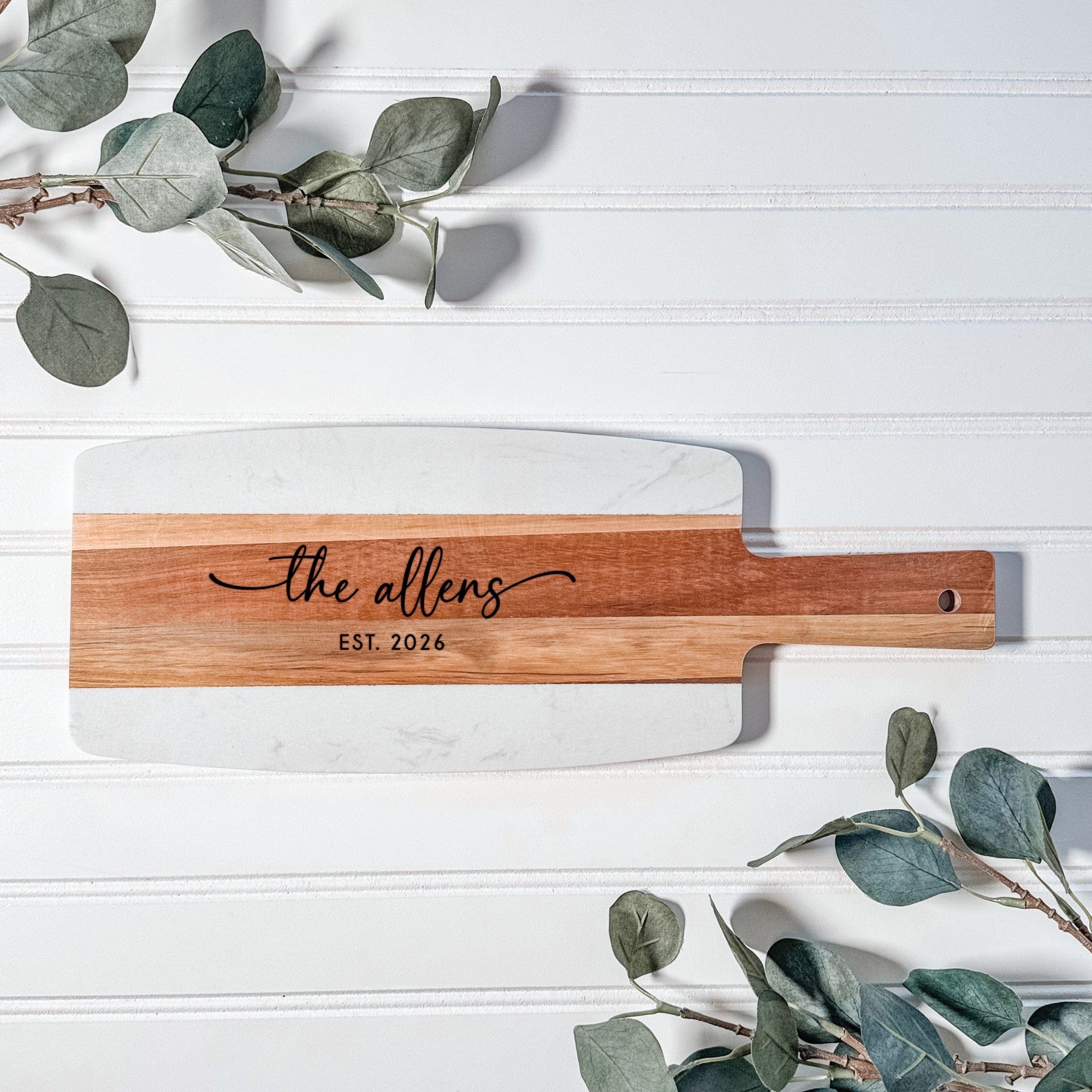 An elegant personalized serving board featuring a rectangular design crafted from white marble and warm-toned wood, perfect for wedding gifts or special event decor.