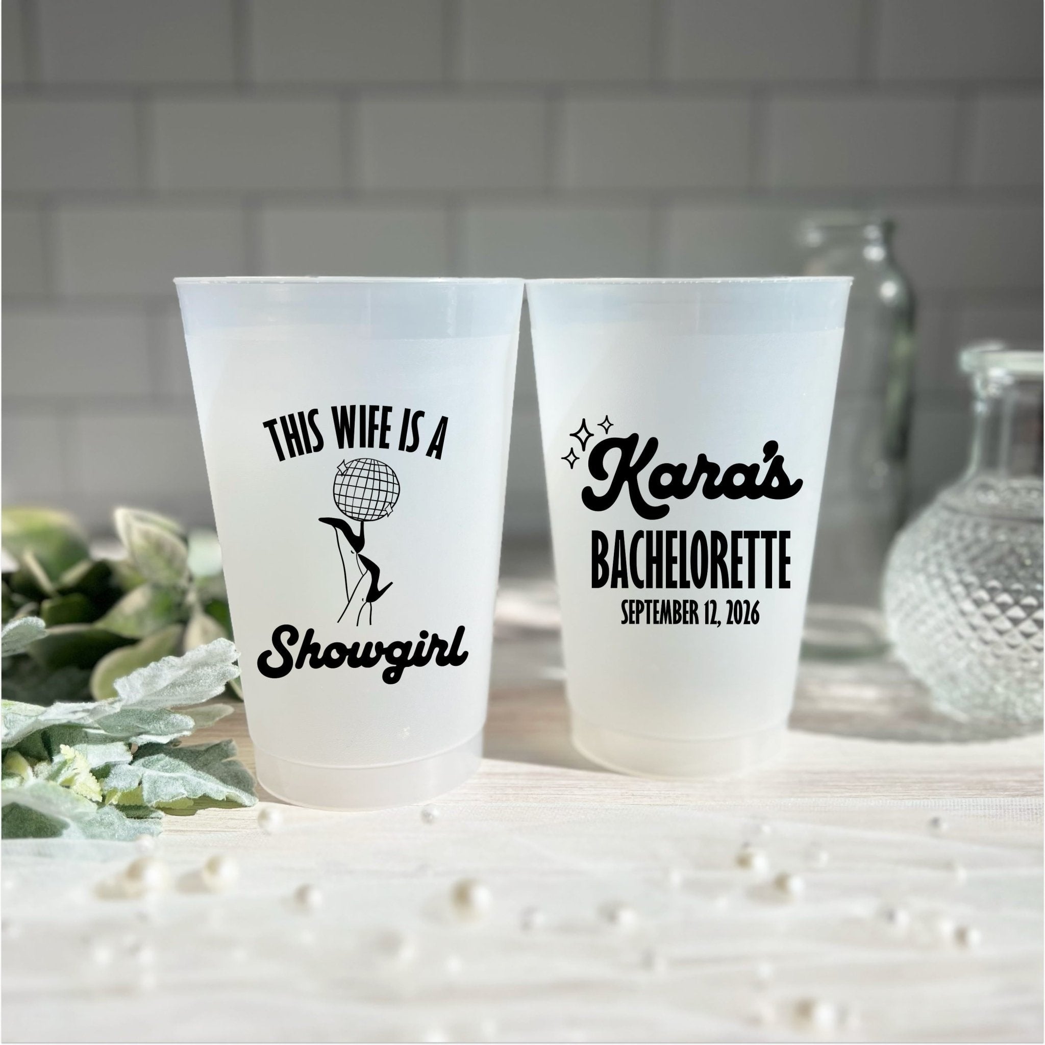 This Wife Is A Showgirl bachelorette cup styled with glassware and decor for a Vegas glam themed bachelorette party