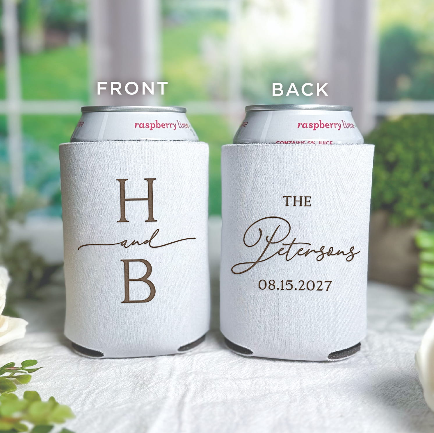 Real photo of personalized standard neoprene can coolers featuring a modern initial monogram, sized to fit a standard 12 oz can for wedding cocktail hour use.