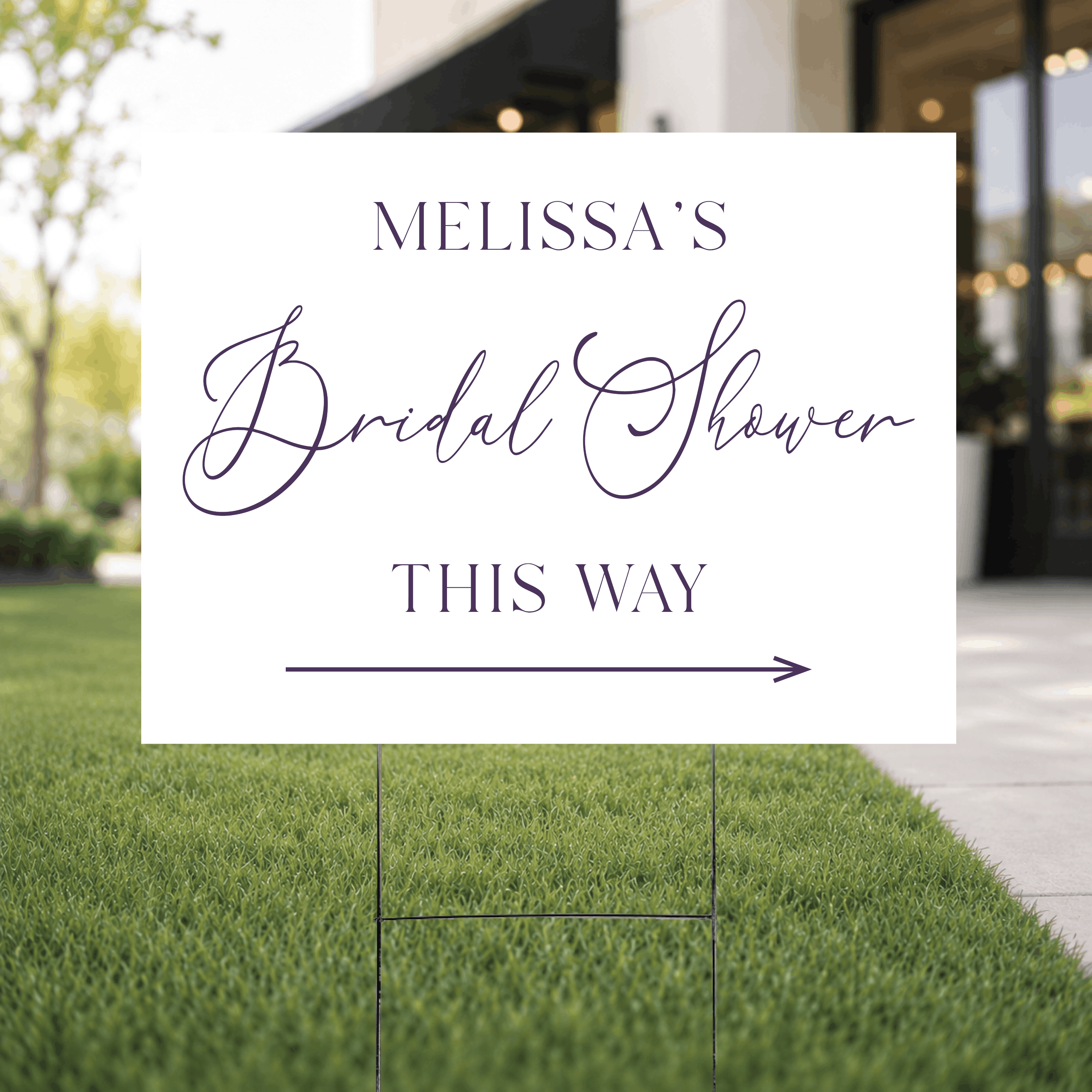 Close-up of a modern script bridal shower directional yard sign showing the minimalist white design with custom UV ink name in flowing script and THIS WAY in bold serif lettering.