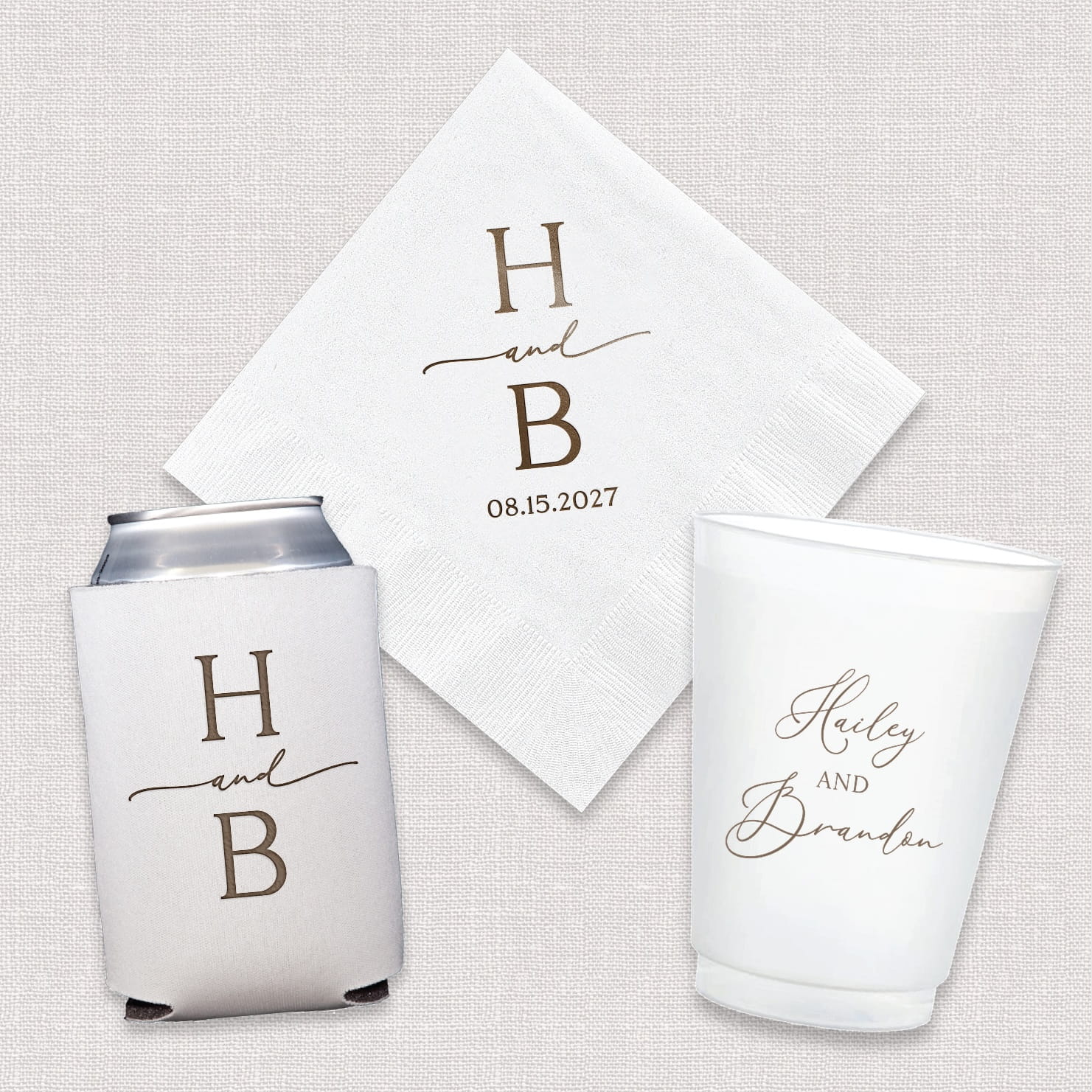 A complete wedding bundle set featuring personalized cocktail napkins, frosted shatterproof cups, and neoprene can coolers with a modern initial monogram design, arranged together as a coordinated suite.