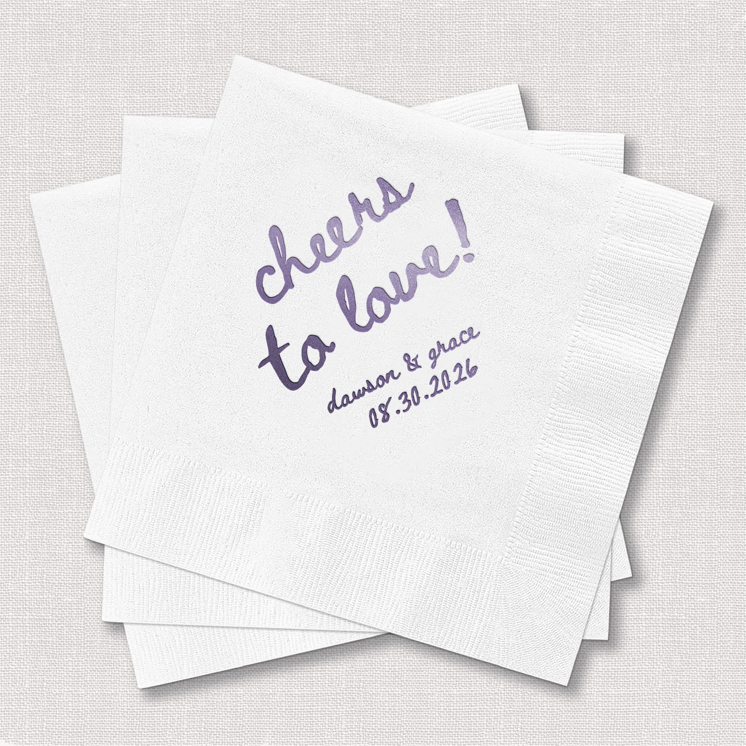 A product photo of a personalized cocktail napkin from the Cheers to Love Wedding Bundle, featuring a festive celebratory design on soft 3-ply paper stock.