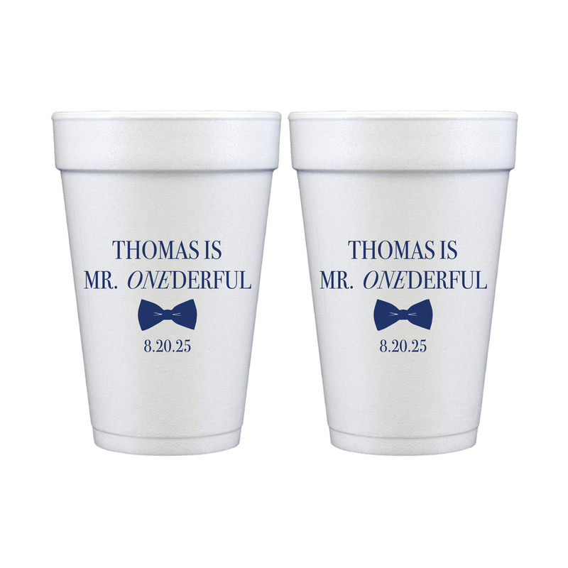 Two white foam cups with navy blue text reading "Thomas is Mr. ONEderful" and date "8-20-25" with a balloon design