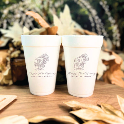Two white foam cups featuring a custom turkey design for a Thanksgiving celebration.