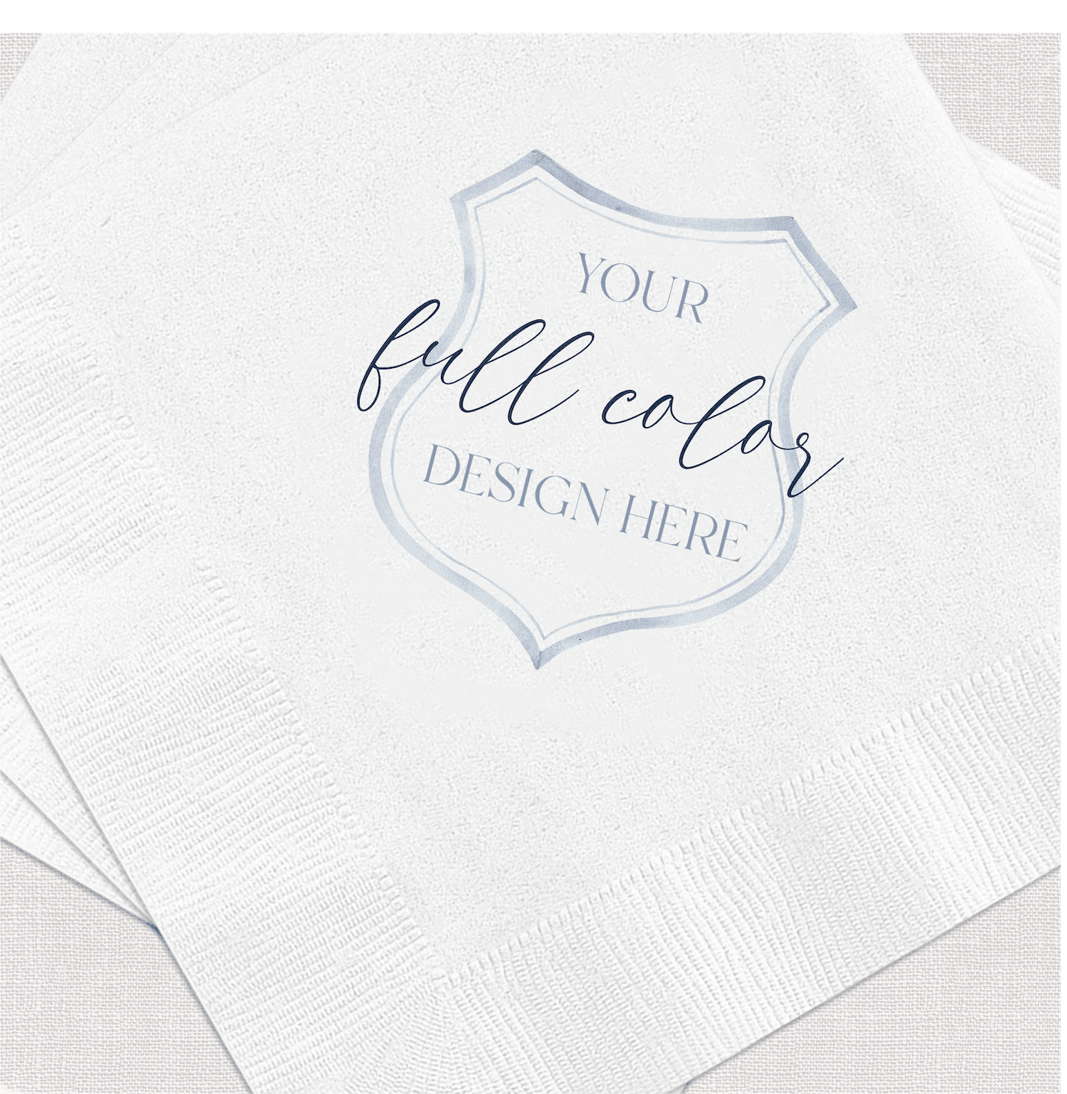 White napkin with blue decorative badge featuring "your full color design here" text in script and sans-serif fonts.