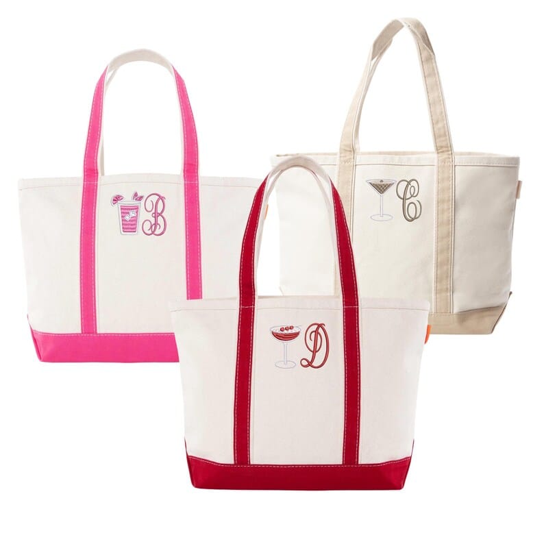 Three canvas tote bags with contrasting colored handles and embroidered monogram initials in pink, burgundy, and beige.