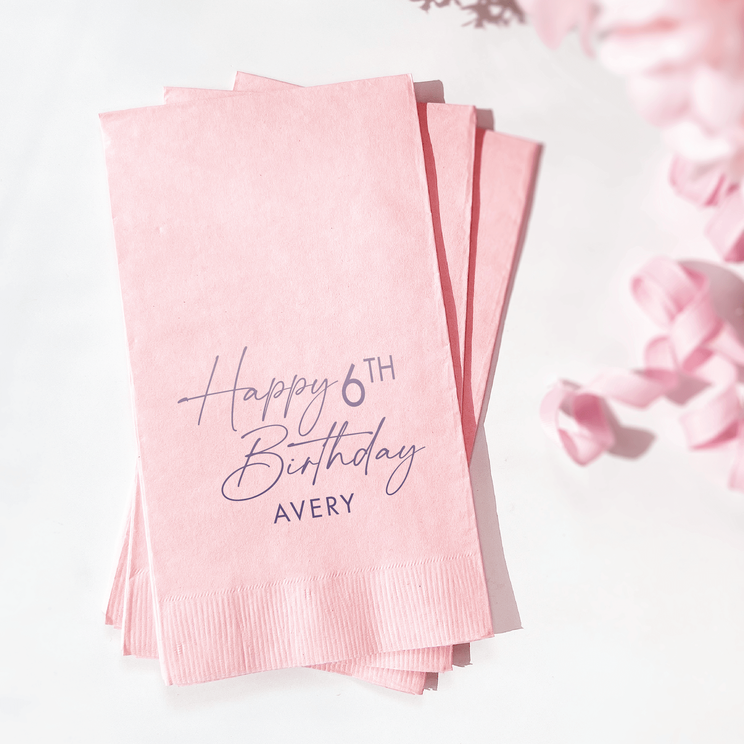 Pink napkins with "Happy 6TH Birthday AVERY" in foil stamped text, fanned display