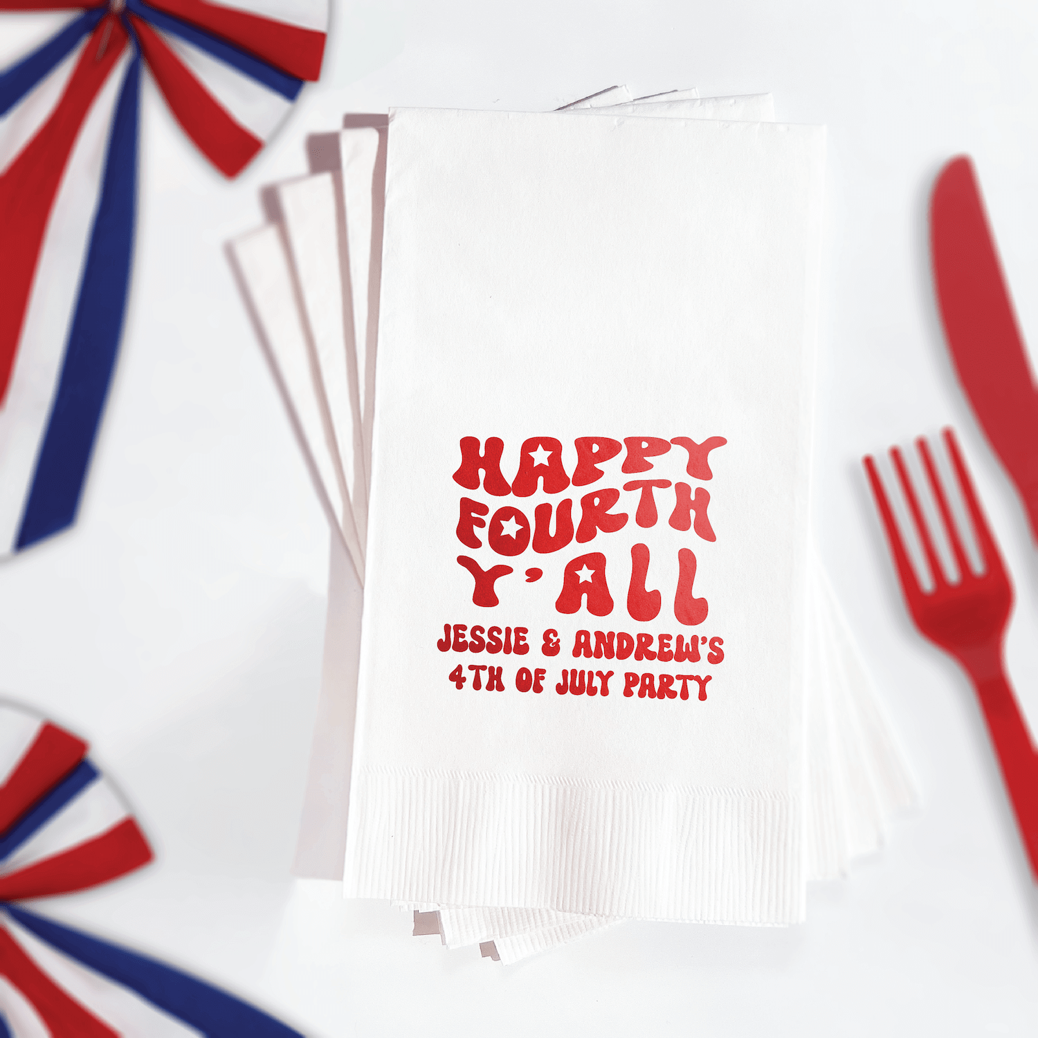 White napkins with red foil stamped text reading "HAPPY FOURTH Y'ALL" and personalized names and date for 4th of July party
