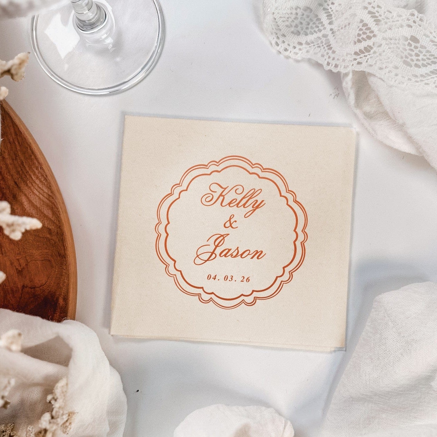 A personalized light beige linen napkin with a custom rust-colored scalloped border design, perfect for elegant wedding or special event place settings.
