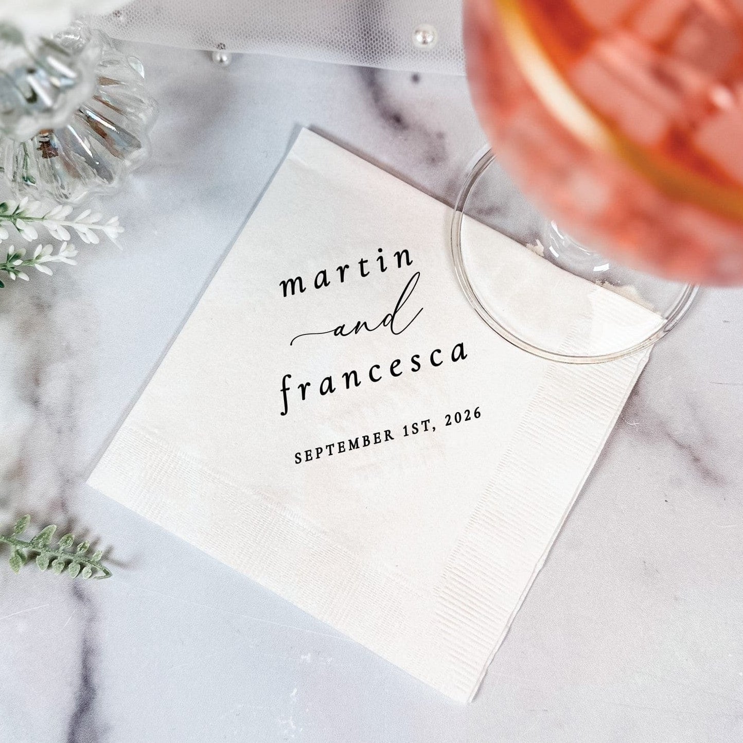 A white paper wedding napkin is personalized with elegant custom text, ready for special event use.