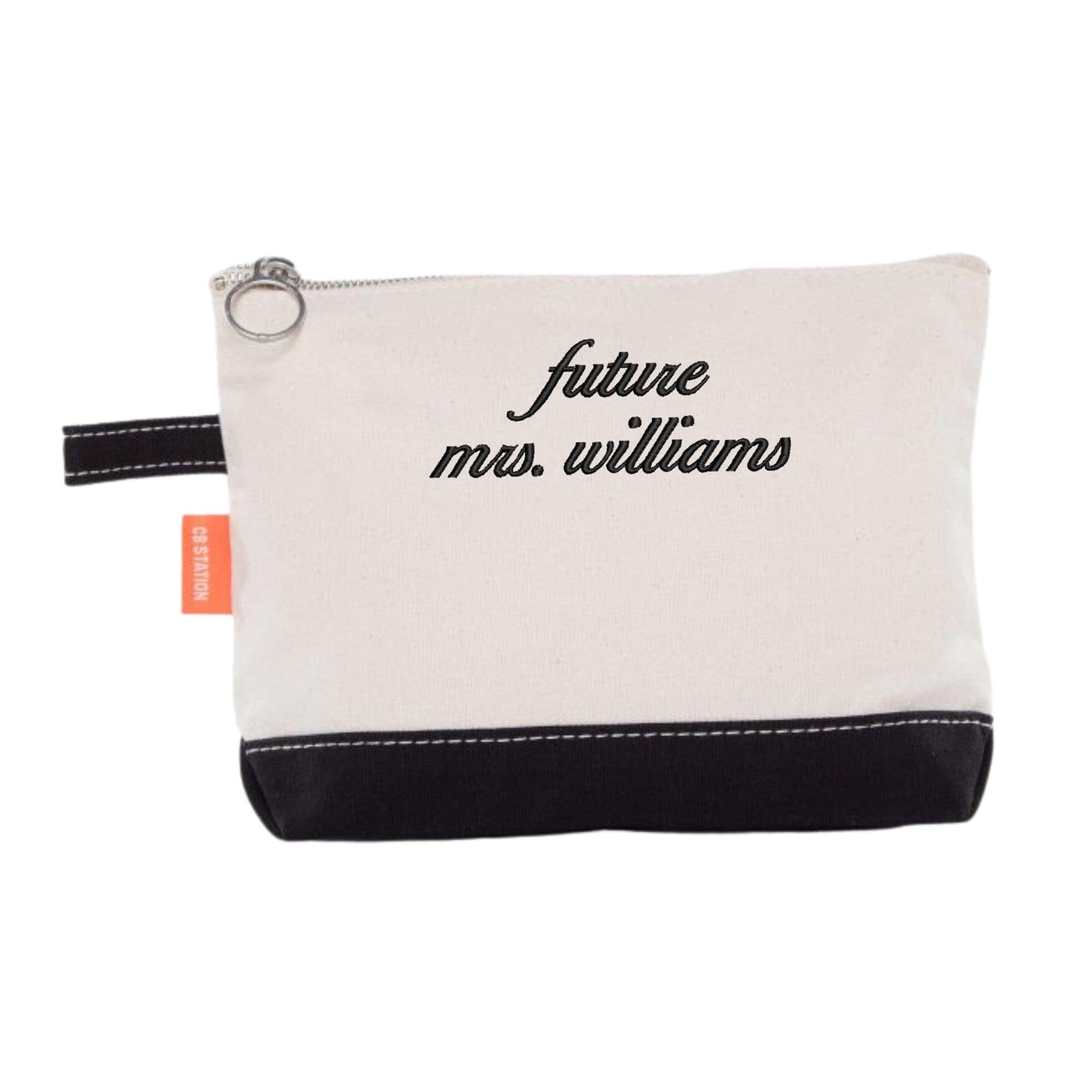 A small, two-tone canvas pouch with a cream top and black bottom, featuring a zippered closure and a side loop, ideal as a personalized gift or accessory for a bridal shower or wedding celebration.