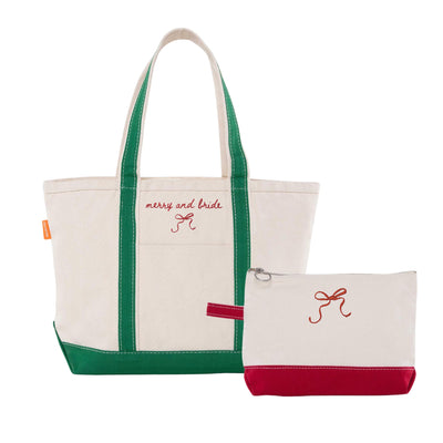 This two-piece canvas bag set, ideal for a bridal event, includes a cream tote bag with green straps and base, and a matching zippered pouch with a red bottom, both embellished with a vibrant red embroidered bow.