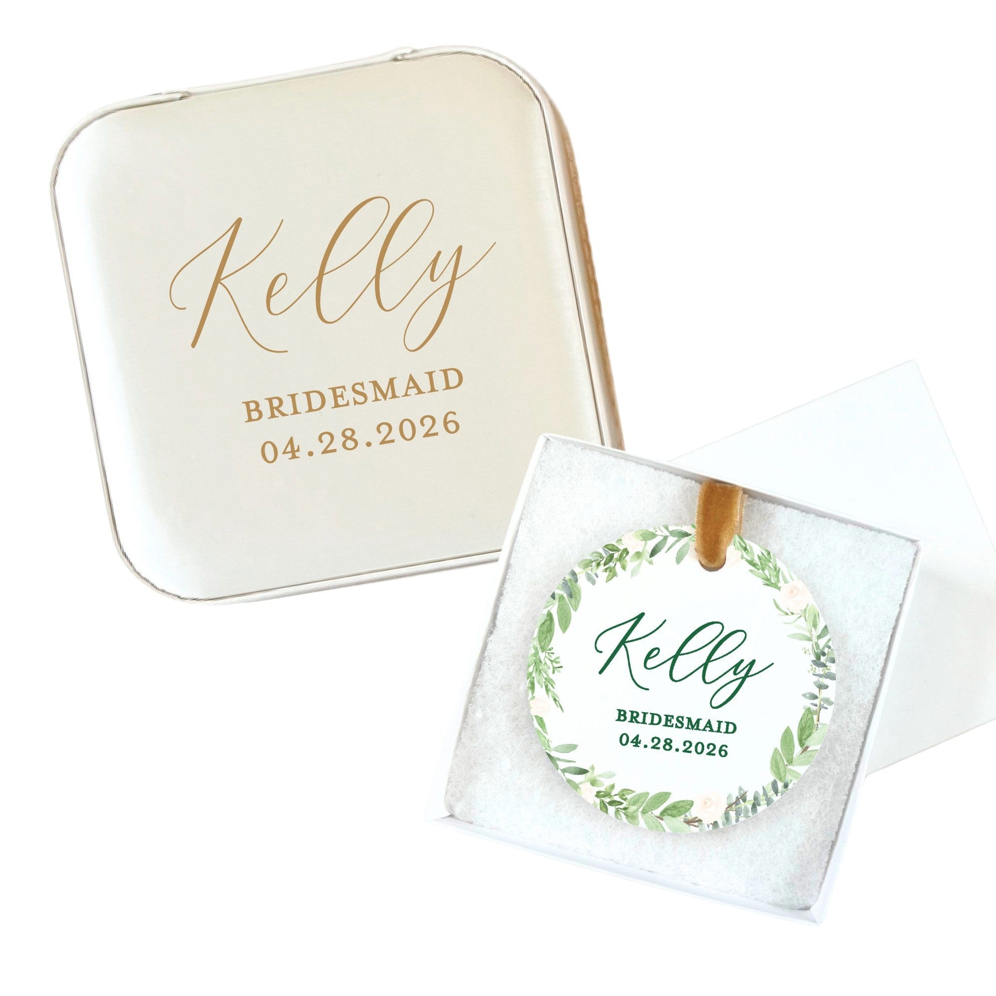 A personalized cream-colored square gift tin is displayed with a round ornament featuring a green botanical wreath design and a gold ribbon, presented in a white gift box, ideal for a wedding or bridal event favor.
