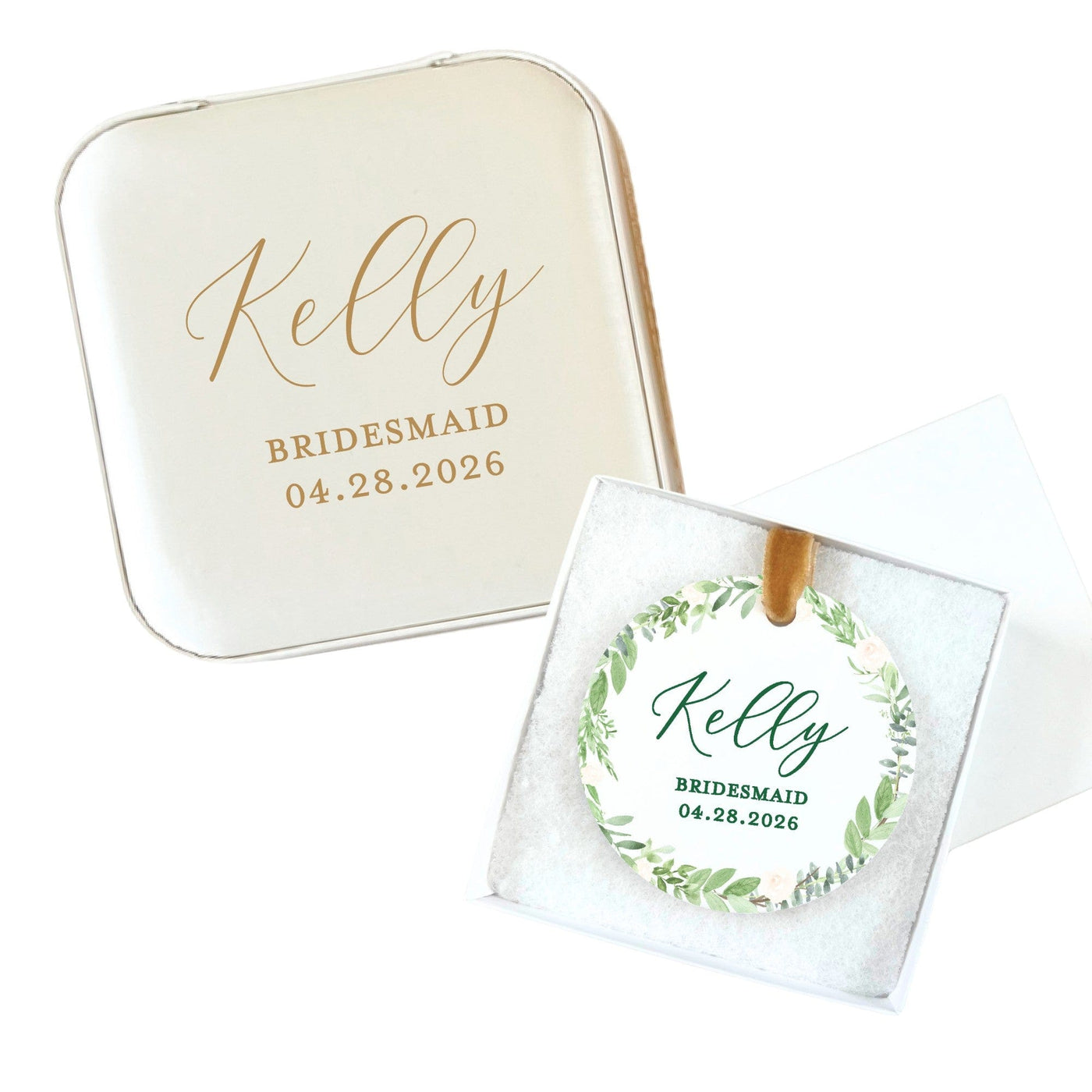 A personalized cream-colored square gift tin is displayed with a round ornament featuring a green botanical wreath design and a gold ribbon, presented in a white gift box, ideal for a wedding or bridal event favor.
