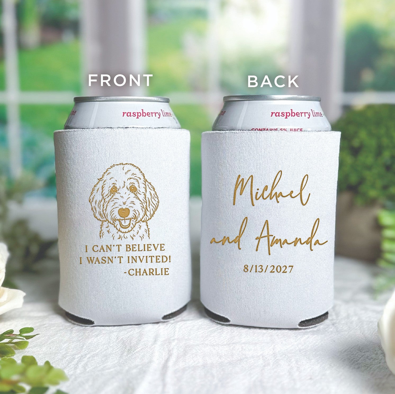 Two white neoprene can coolers are displayed, one featuring a whimsical gold dog illustration with a humorous phrase and the other with elegant gold script, intended as personalized wedding event favors to keep beverages chilled.