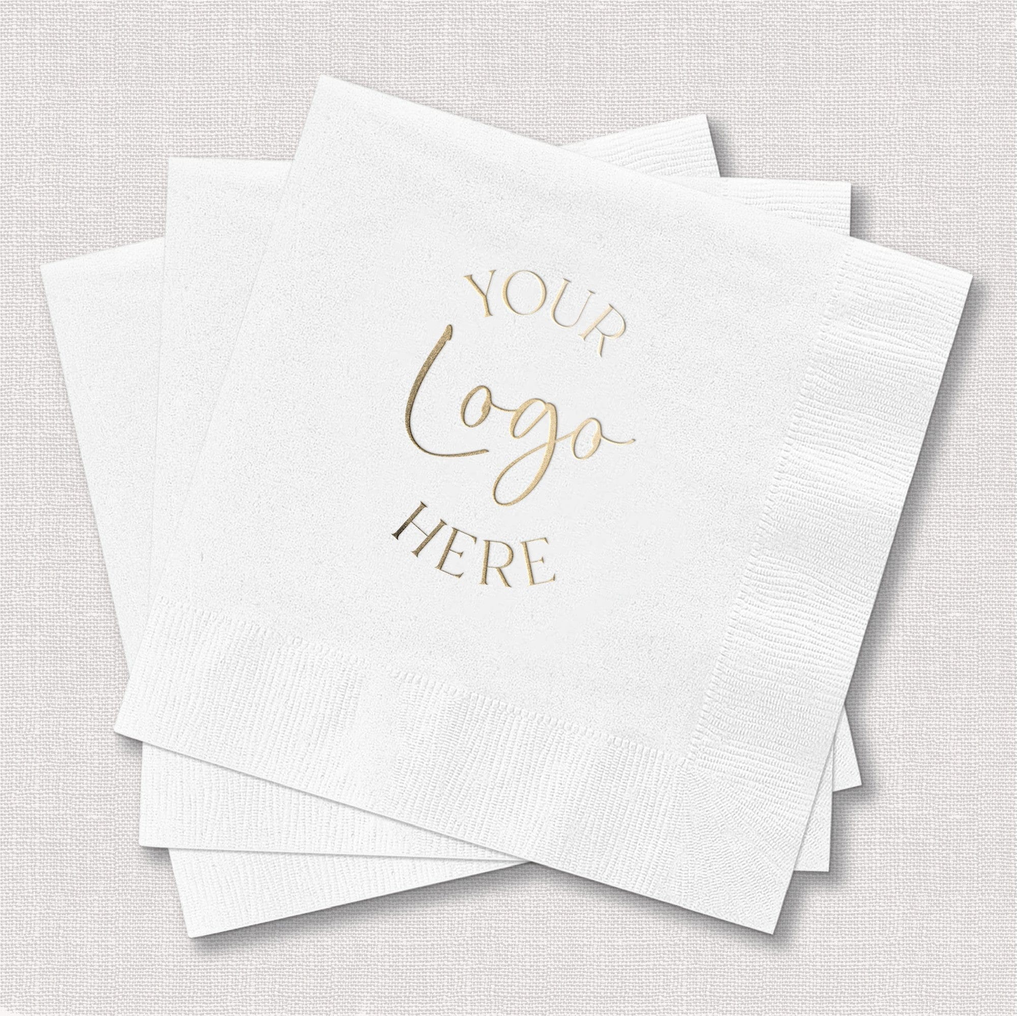 A stack of textured white paper cocktail napkins designed for custom foil personalization, suitable for a wedding or special event.