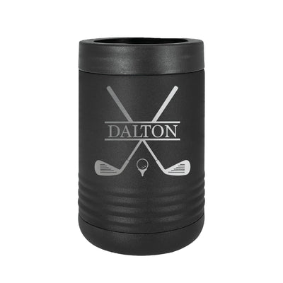 A black insulated can cooler featuring an engraved golf design with crossed clubs and a golf ball on a tee, revealing the silver metal beneath, perfect for keeping beverages cold.