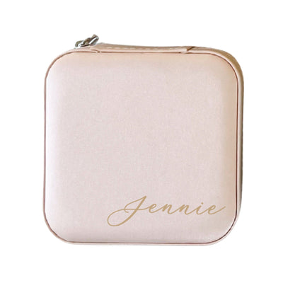 A compact, blush pink zippered jewelry case made from soft material, ideal for storing small accessories or as a wedding party gift.