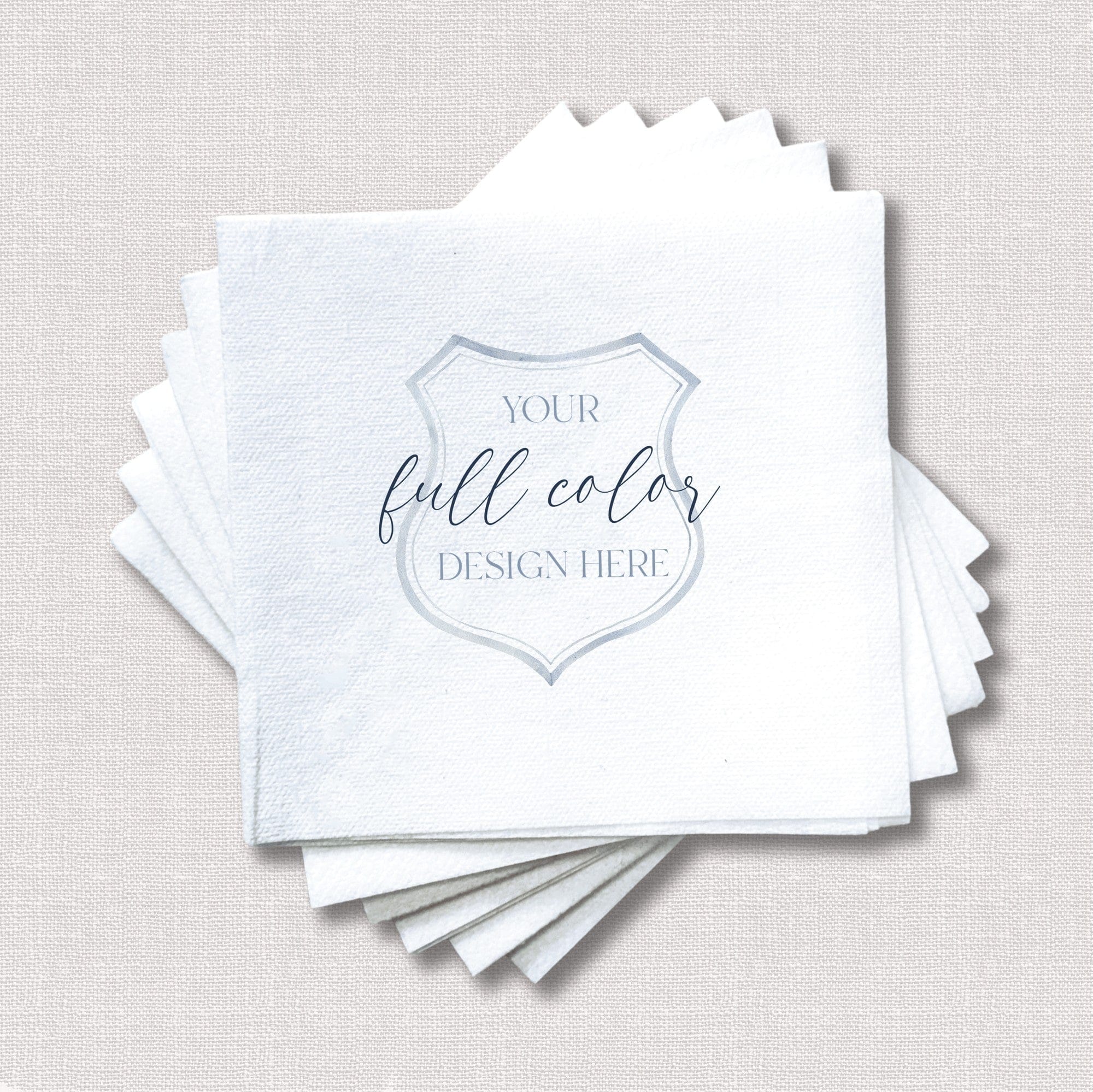 A stack of plain white textured disposable paper napkins, customizable with a full-color design for wedding or event decor.