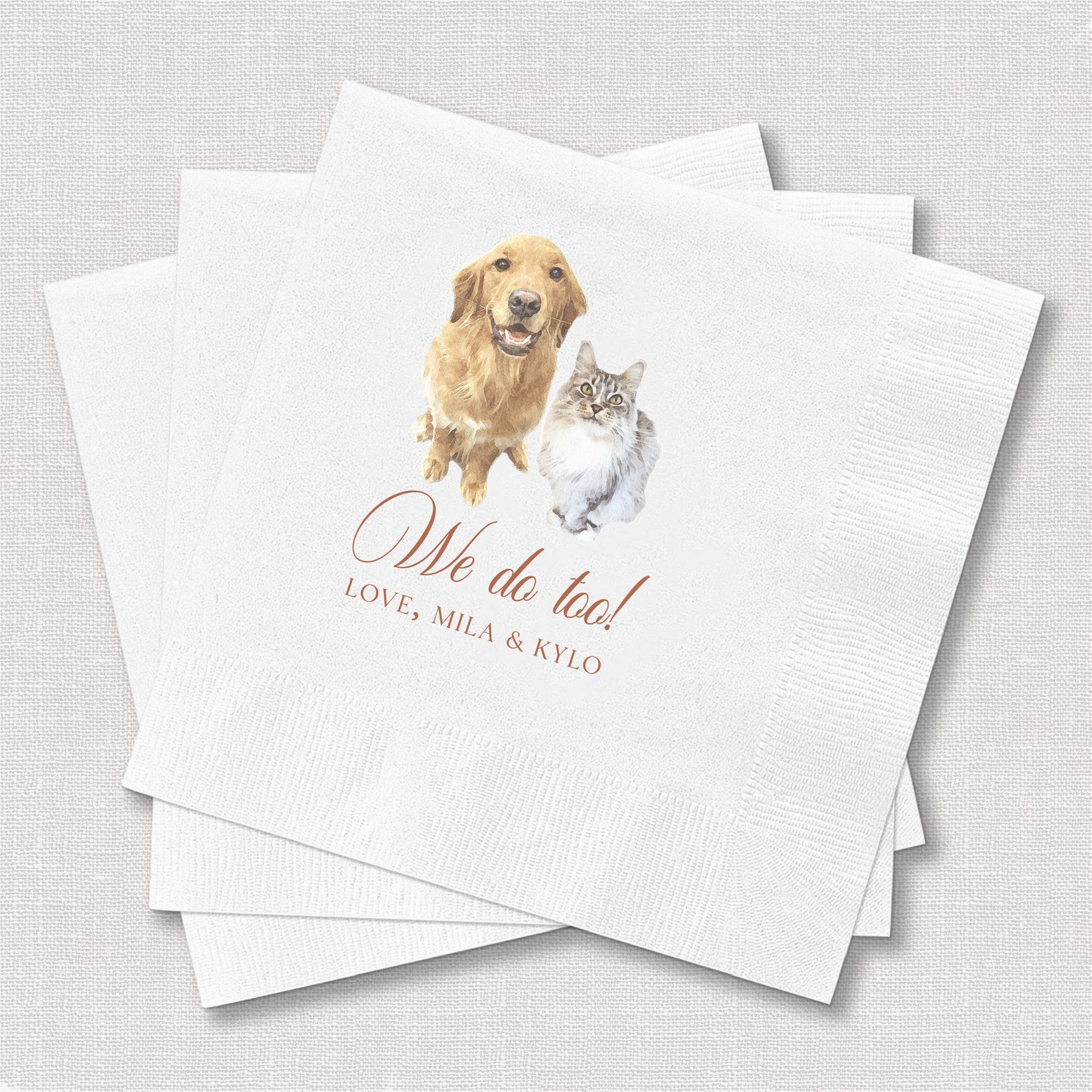 A stack of white paper wedding napkins customized with a watercolor illustration of a golden retriever and a grey cat, serving as unique event decor.