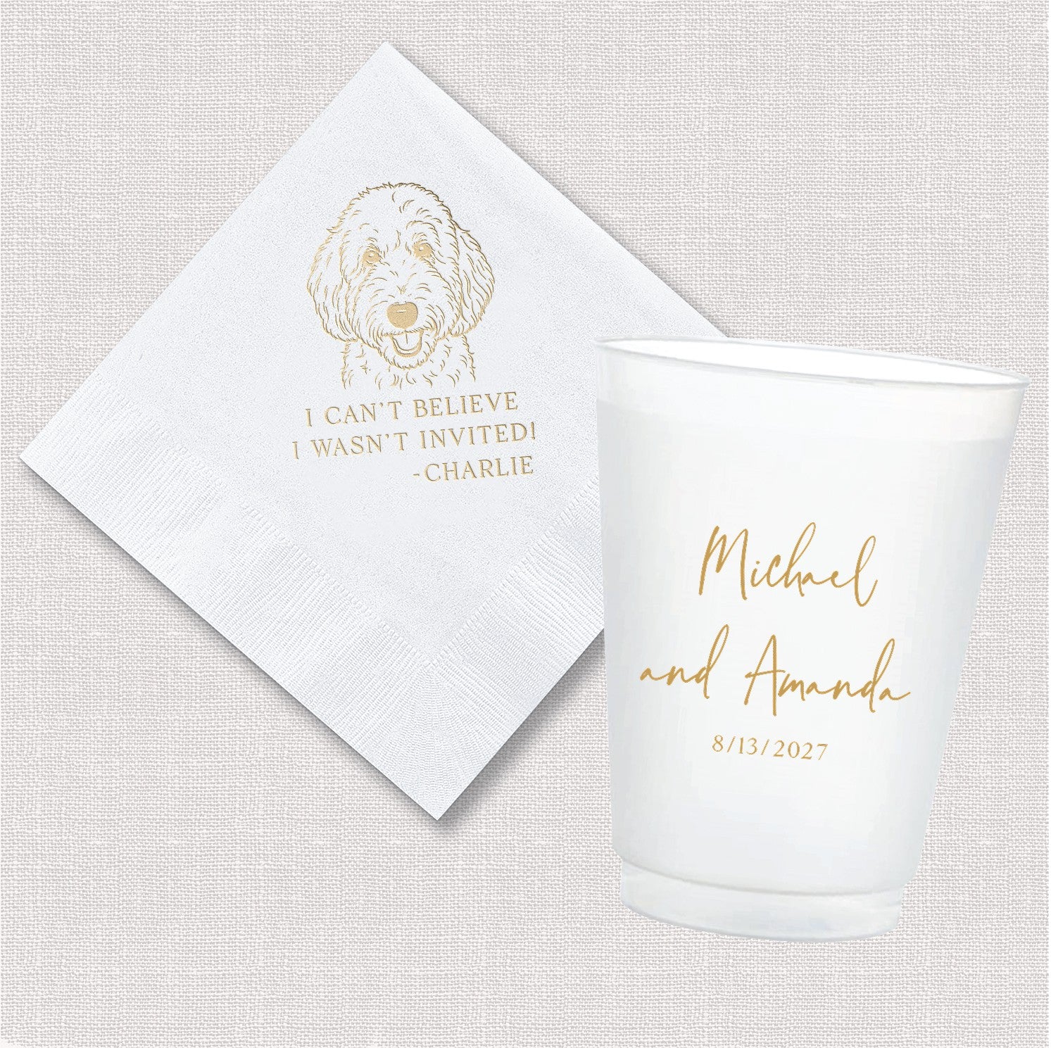 A white paper napkin featuring a gold foil dog illustration and a white plastic shatterproof cup with a personalized gold foil design, perfect for event celebrations.