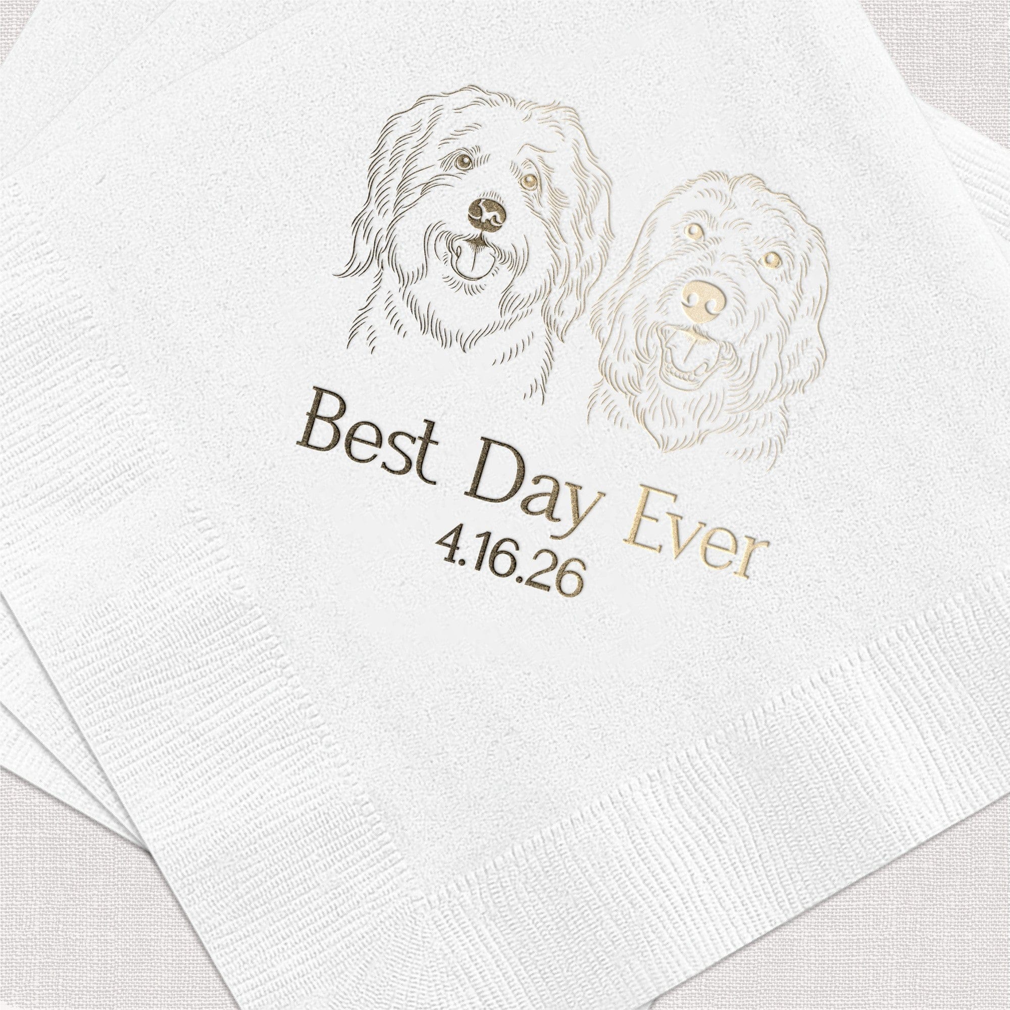 A stack of white textured wedding napkins featuring a custom metallic gold foil illustration of two happy dogs and personalized metallic text.