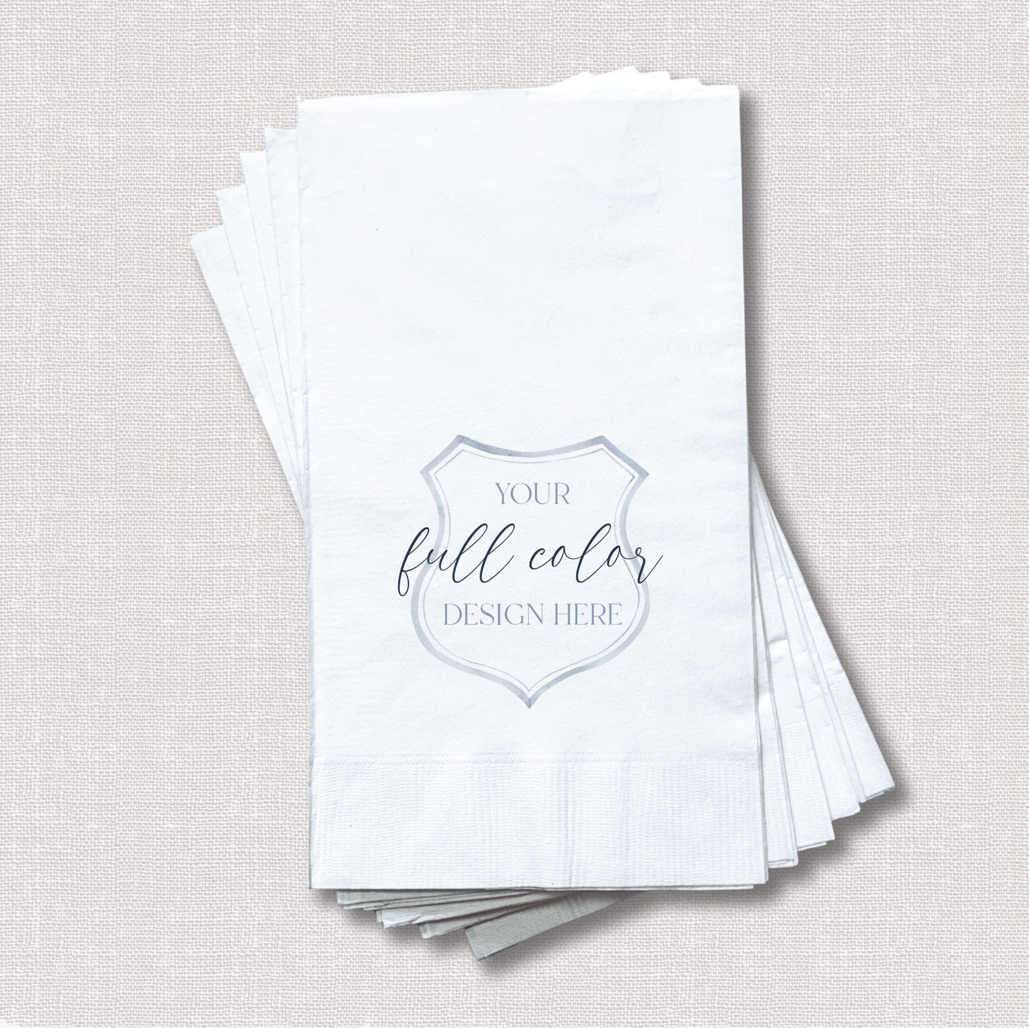 A stack of white rectangular paper guest towels, featuring a placeholder for a customizable full-color design, ideal for personalized wedding or event decor.