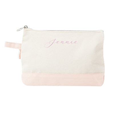 A two-tone personalized canvas pouch with a cream upper section and a light pink bottom, featuring a zippered closure and a side loop, suitable for holding cosmetics or small accessories.