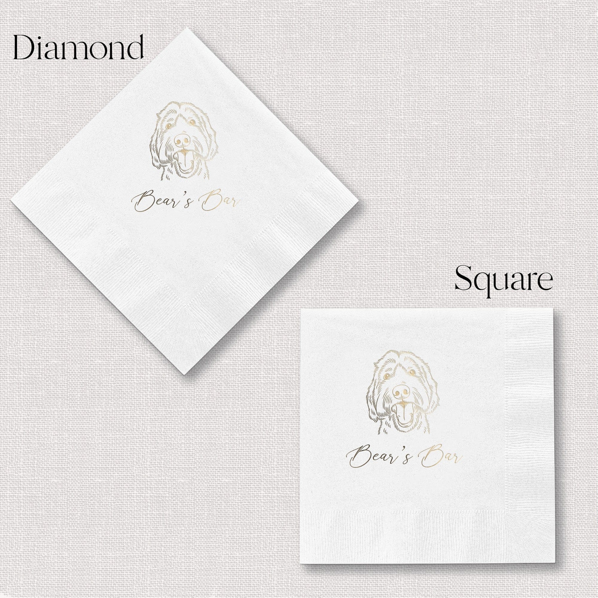 Two white paper event napkins, one diamond-shaped and one square, are personalized with a gold foil dog illustration and script typography.