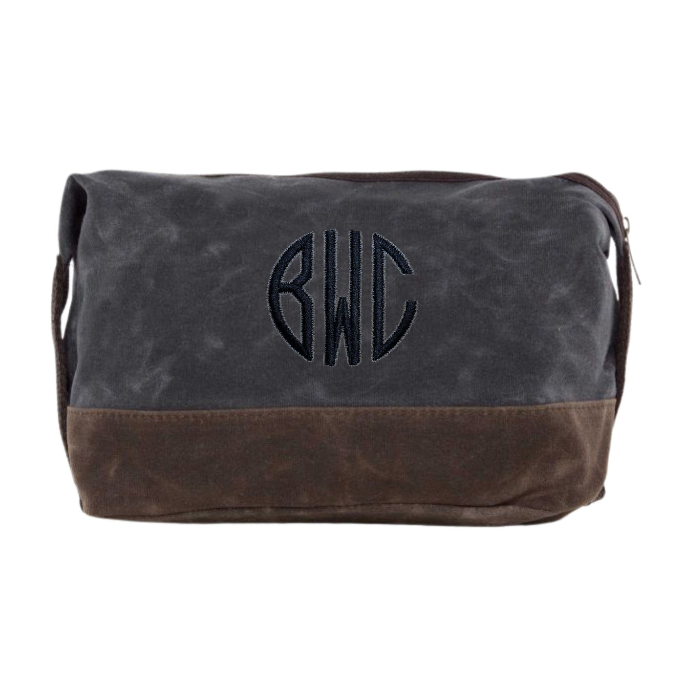 A personalized two-tone waxed canvas toiletry bag in dark grey and brown, featuring an embroidered circular monogram design and a top zipper closure, perfect for travel essentials or as a wedding party gift.