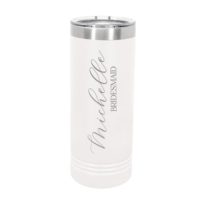 A white insulated skinny tumbler with a silver top band and clear lid, featuring custom gray script lettering, designed as a personalized gift for a bridal party.