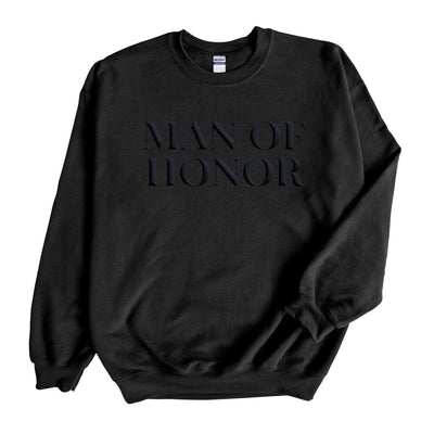 A comfortable black crewneck sweatshirt features a subtle dark, raised design on the chest, perfect for a wedding party member.