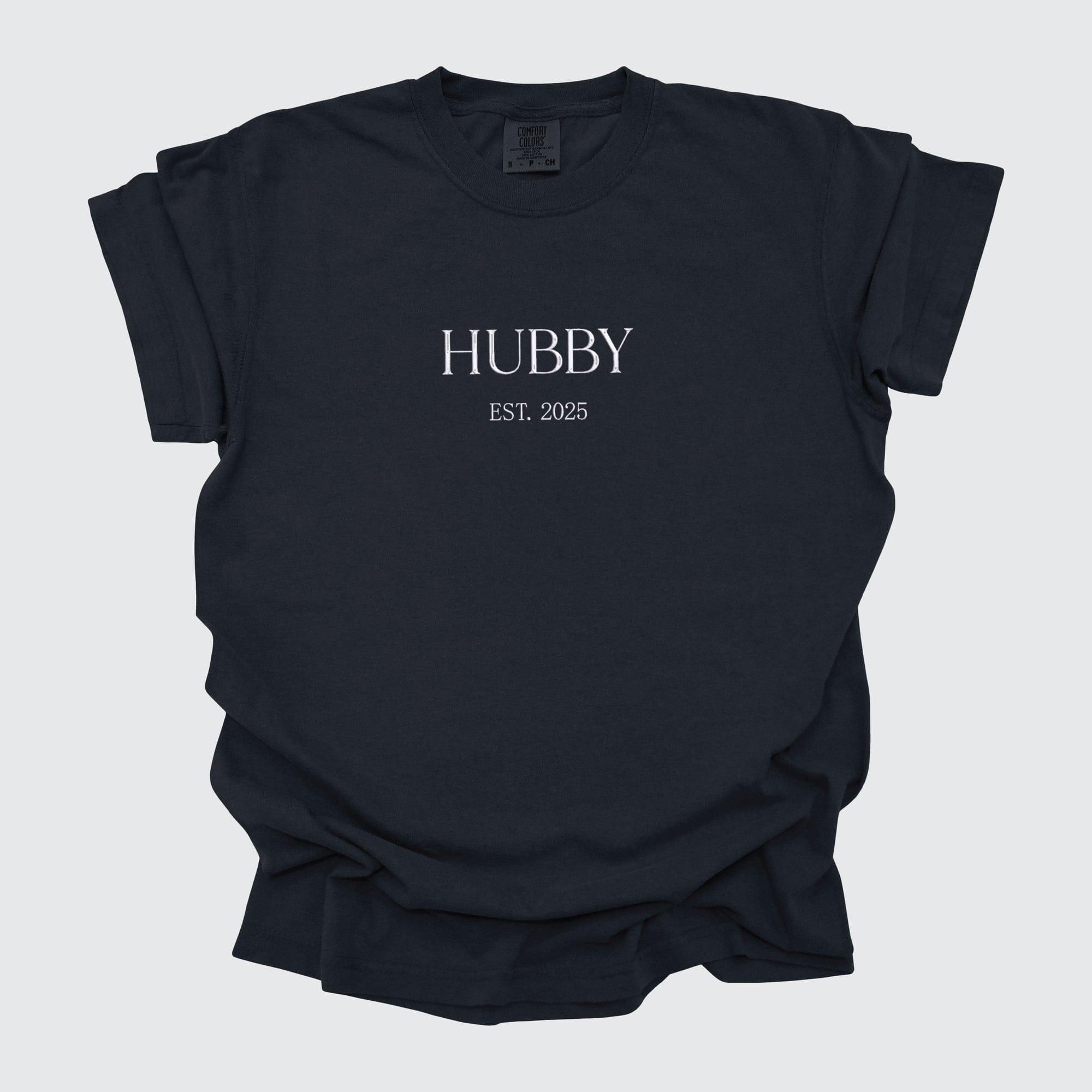 A dark-colored, short-sleeved t-shirt made from soft fabric, suitable for a groom or bridal party member to wear for wedding-related events.