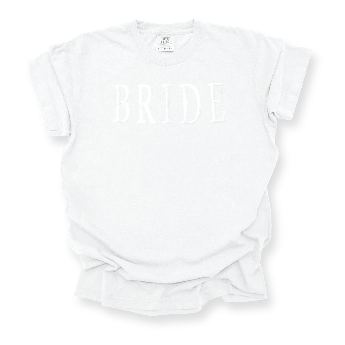 A white short-sleeve t-shirt features subtle white raised lettering, perfect for bridal events.