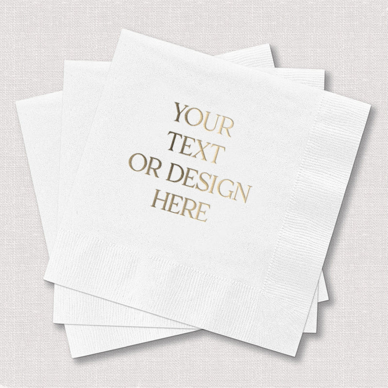 A stack of white, textured paper cocktail napkins, designed for custom metallic foil printing, suitable for wedding receptions or special events.