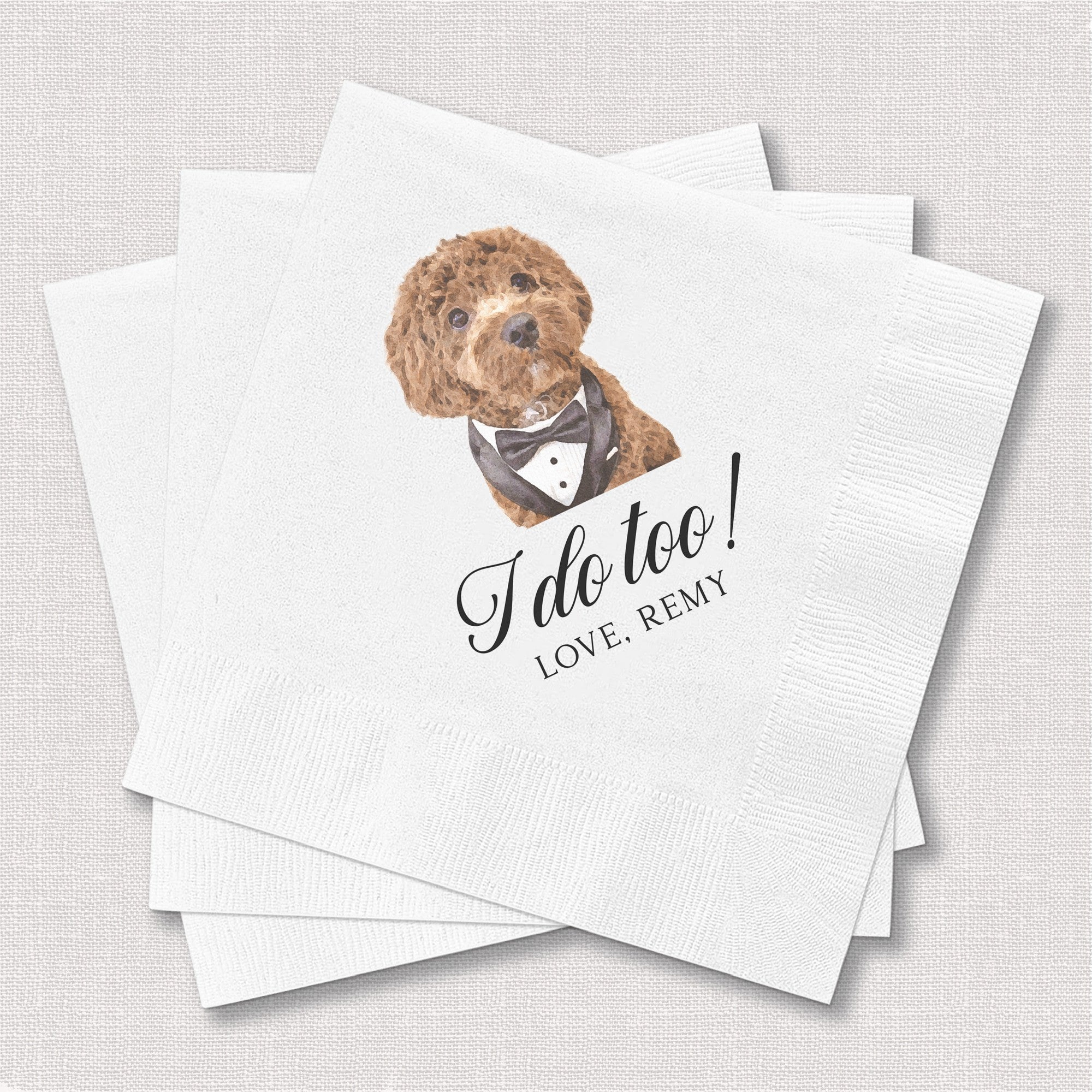 A stack of white paper cocktail napkins featuring a watercolor illustration of a brown dog wearing a tuxedo, perfect for a wedding or celebratory event.
