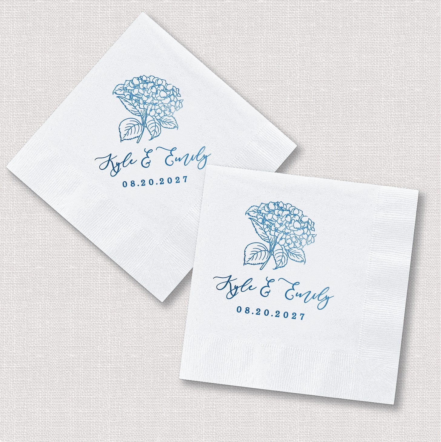 White paper wedding napkins feature a vibrant blue line-art hydrangea floral design, personalized for a special event.