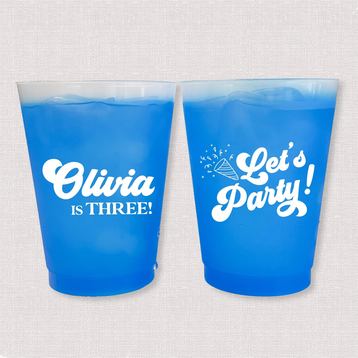 Blue color changing frosted kids birthday cups with Olivia is Three name and Let's Party design