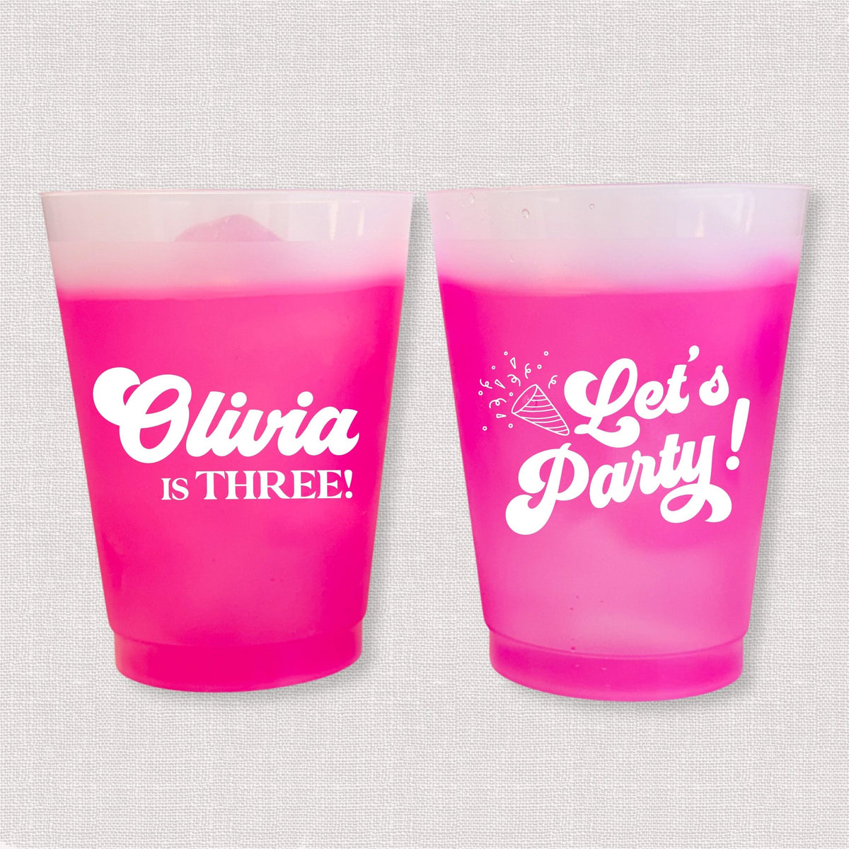 Magenta color changing frosted kids birthday cups with Olivia is Three name and Let's Party design
