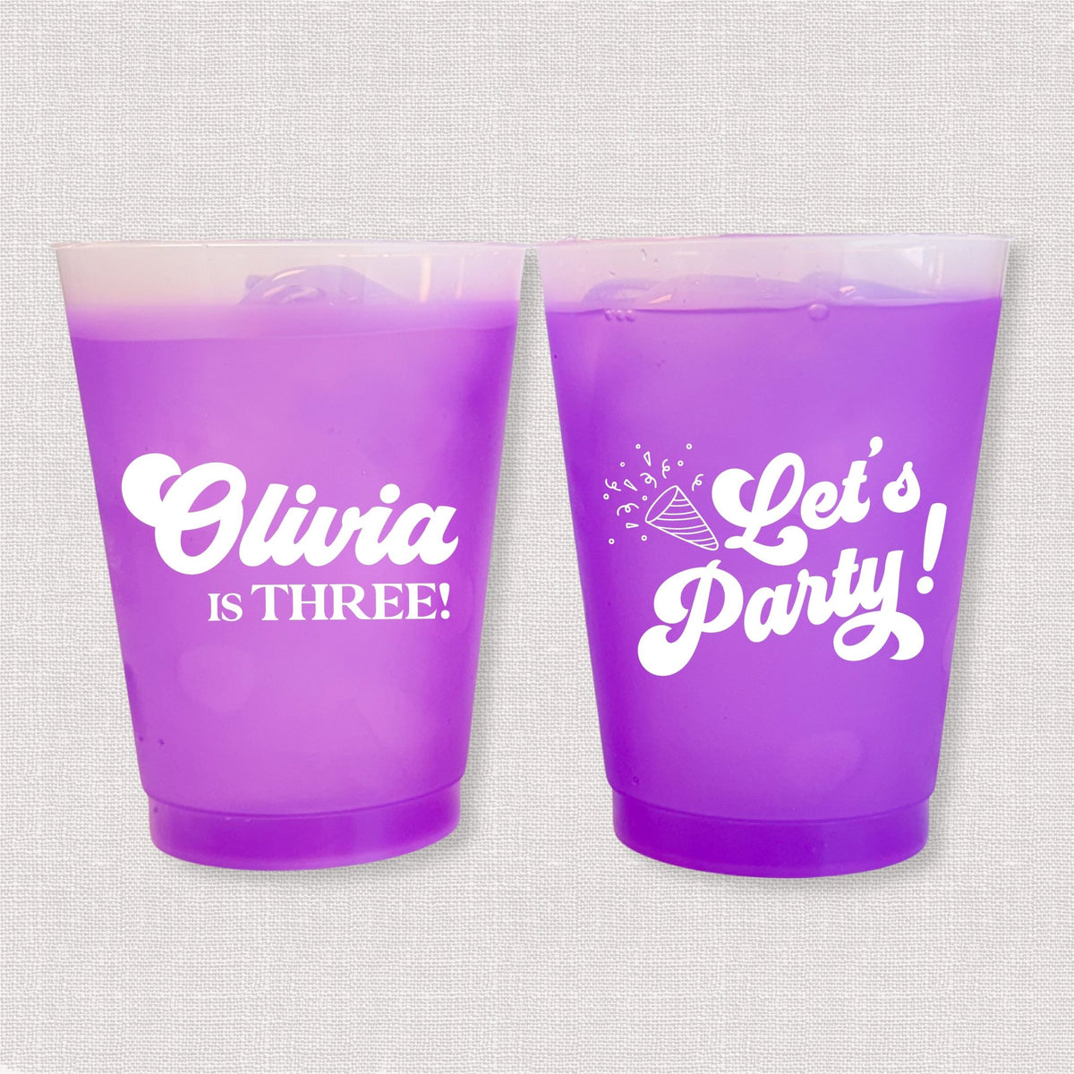 Purple color changing frosted kids birthday cups with Olivia is Three name and Let's Party design