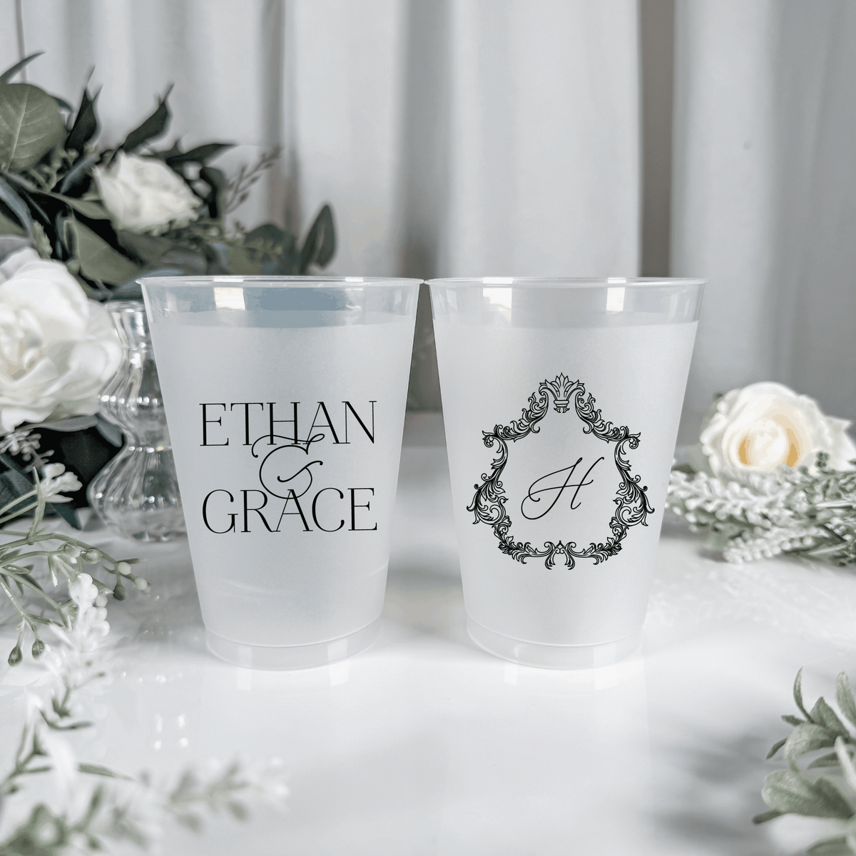 Black ink frosted shatterproof wedding cups with Ethan & Grace names and ornate crest H monogram