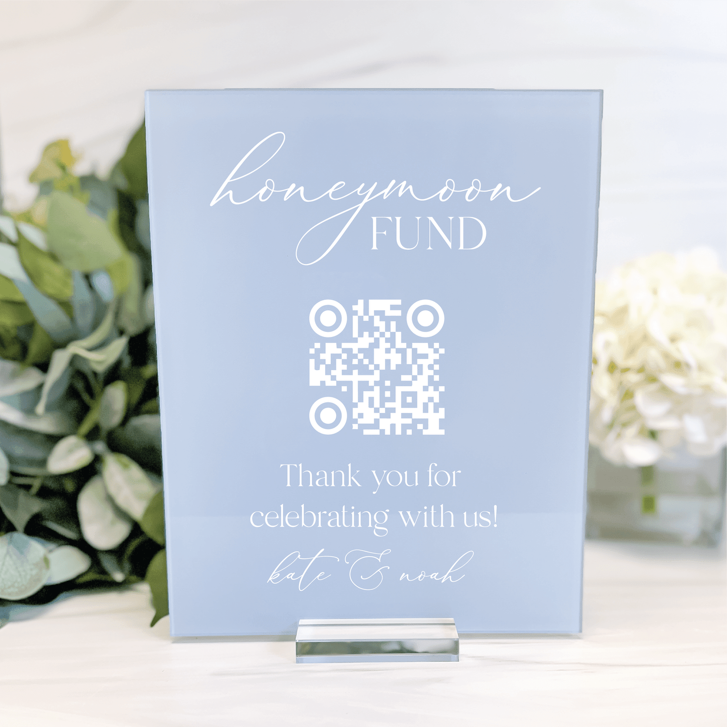 Light blue acrylic sign with "honeymoon FUND" text, QR code, and "Thank you for celebrating with us" message for weddings