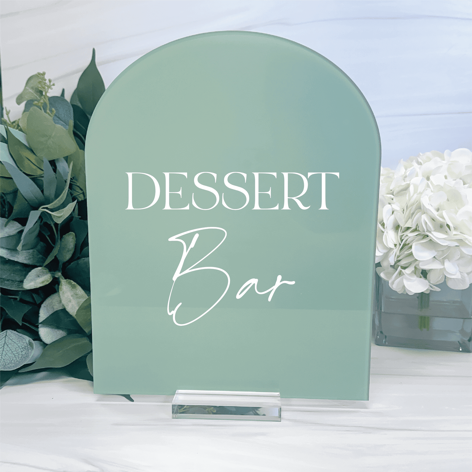 Sage green acrylic arch sign with white text reading "DESSERT Bar" for event displays