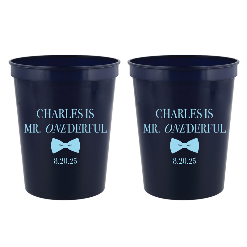 Navy stadium cups with light blue bow tie design and "Charles is Mr. Onederful 8.20.25" personalization text